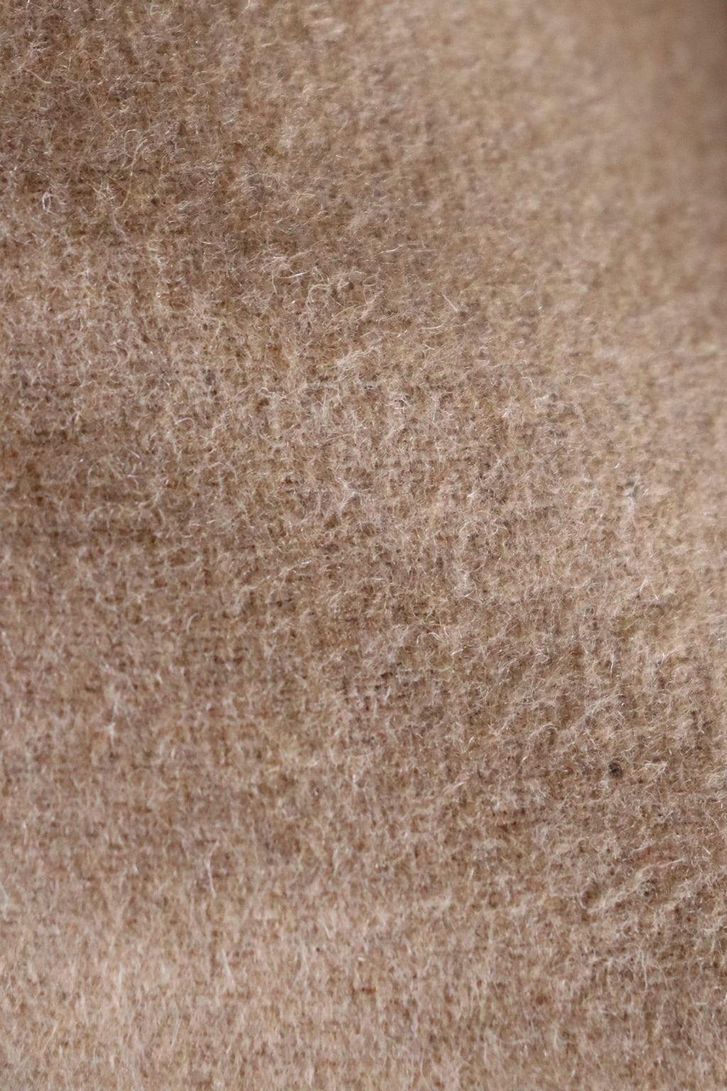 Een close-up afbeelding van een beige wollen stof.